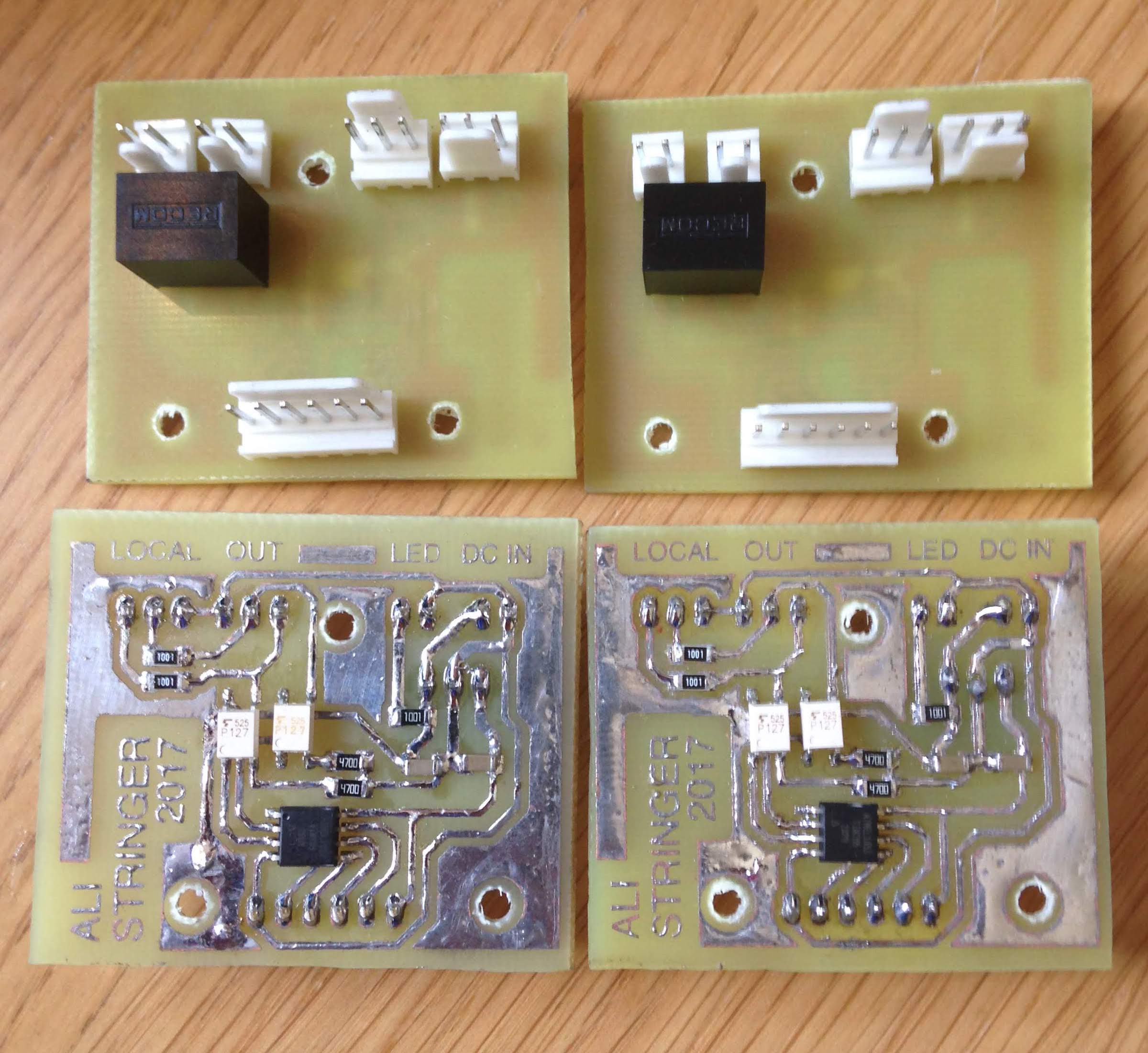 Home-brew control printed circuit boards. Yellowish green single sided PCB with surface mount components on the copper side and connectors on the component side.